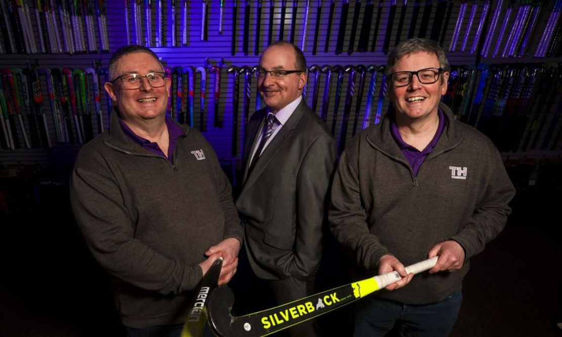 Ulster Bank’s Derick Wilson (centre) with Alan McMurray (left) and Steven McMurray (right) of Total Hockey.