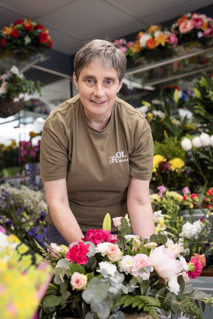 Lady working with flowers in a florists